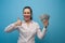 Happy young emotional caucasian woman holding dollar banknotes in her hands