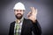 Happy young engineer with white hardhat showing ok sign