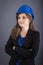 Happy young engineer woman with hardhat and arms folded