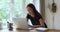 Happy young european appearance woman in eyeglasses studying on computer.