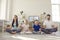 Happy young family with children practicing meditation and reaching zen in lockdown