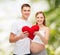 Happy young family expecting child with big heart