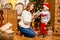 Happy young family, father, mother and son, in Christmas evening in home. Mom and son decorate Christmas tree. New Year`s and