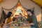 Happy young family having breakfast by glamping tent