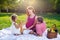 Happy young family having picnic at meadow