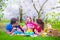 Happy young family with kids having picnic outdoors