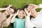 Happy Young Family lying on the grass