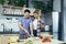 Happy young family, man and woman, cooking together, Asian cuts vegetables, date at home, romantic evening