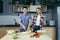 Happy young family, man and woman, cooking together, Asian cuts vegetables, date at home, romantic evening