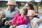 Happy young family- mom,dad and two children teenage girl and little daughter traveling together and relaxing in street cafe