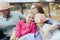 Happy young family- mom,dad and two children teenage girl and little daughter traveling together and relaxing in street cafe