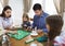 Happy young family plaing board game
