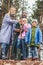 happy young family in raincoats