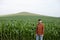 Happy young farmer in a corn field. Successful agricultural business. Copyspace