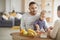 Happy Young Father Enjoying Breakfast with Family