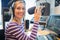 Happy young female radio host broadcasting in studio