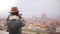 Happy young female traveler walks up, taking smartphone photo of amazing cityscape panorama of autumn Florence, Italy.