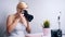 Happy young freelance photographer photographing plant in her home