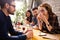 Happy young friends hangout in coffee shop