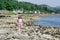 Happy young girl on the beach at Tighnabruaich in Argyll and Bute on the west coast of Scotland during the summer