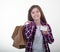 Happy young girl holding discount white card and shopping bags in her hands. Girl with credit card