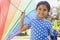 Happy young girl holding kite at park