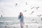 happy young girl in merino sweater on winter seashore