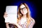 Happy young girl with nerd glasses holding exercise book