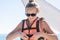 Happy young girl Parasailing in Dominicana beach in summer. Couple under parachute hanging mid air. Having fun. Tropical Paradise.