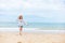 Happy young girl walking on the beach. Summer travel, vocation, holiday concept