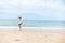 Happy young girl walking on the beach. Summer travel, vocation, holiday concept