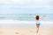 Happy young girl walking on the beach. Summer travel, vocation, holiday concept