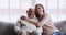 Happy young granddaughter embracing old grandfather sit on sofa, portrait