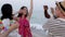 Happy young group of multiracial people dancing at beach party in summer holiday