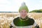 Happy young handsome man smiling against scenic view of autumn bulrush field