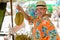 Happy young handsome tourist man buying durian at the street market