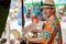 Happy young handsome tourist man buying durian at the street market