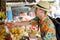 Happy young handsome tourist man buying at the street market