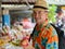 Happy young handsome tourist man shopping at the street market