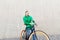 Happy young hipster man with fixed gear bike