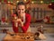 Happy young housewife showing jar with honey nuts