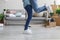 Happy young husband hugs and lifts his wife in own apartment with cardboard boxes