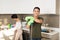 Happy young husband and wife cleaning together in the kitchen. Cleaning concept