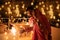 Happy young indian couple celebrating diwali festival both holding sparkler in hand and wearing traditional wear or ethnic outfit