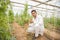 Happy young indian farmer collects harvest organic cucumbers from his poly house or greenhouse, A man Thumbs up with one hand,