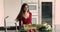 Happy young Indian woman cooking, dancing at home