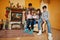 Happy young large family at home by a fireplace in warm living room on winter day