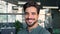 Happy young Latin business man looking at camera in office, headshot portrait.