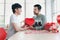 Happy young LGBT couple sharing special moment together on Valentine Day, Asian gay male lover giving red heart gift box present