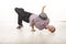 Happy young male dancer sitting on his head smiling